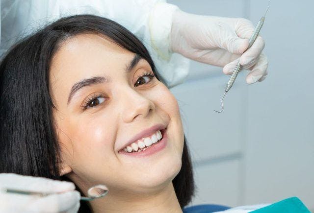 Young woman in the dentist smiling before her procedure.