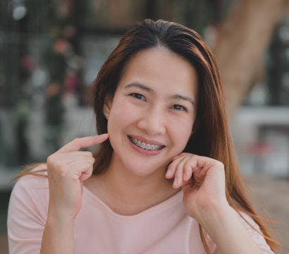 Asian woman with braces smiling.