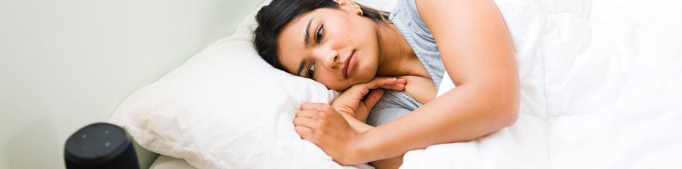 Woman awake next to husband in bed