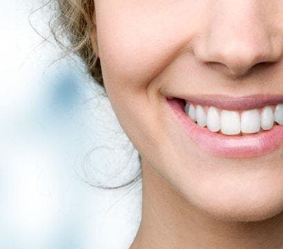Cropped photo of a woman smiling.