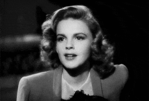 Black-and-white gif of Judy Garland smiling.