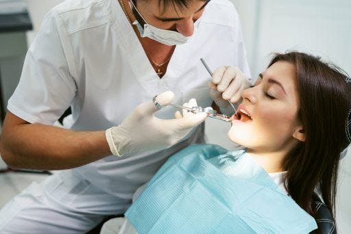 Dark-haired woman getting a dental checkup.