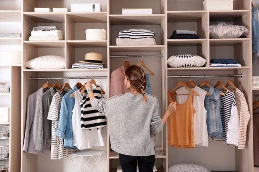 A woman organising her wardrobe.