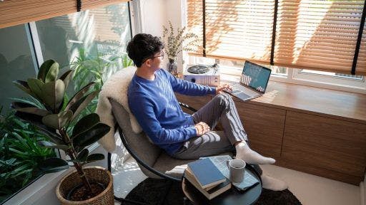  man working on his laptop in a quiet, secluded corner.