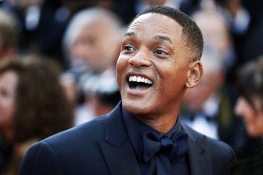 Will Smith smiling during a red-carpet event.