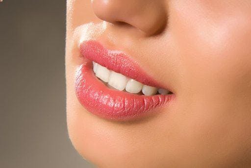 Cropped photo of woman with pink lips.
